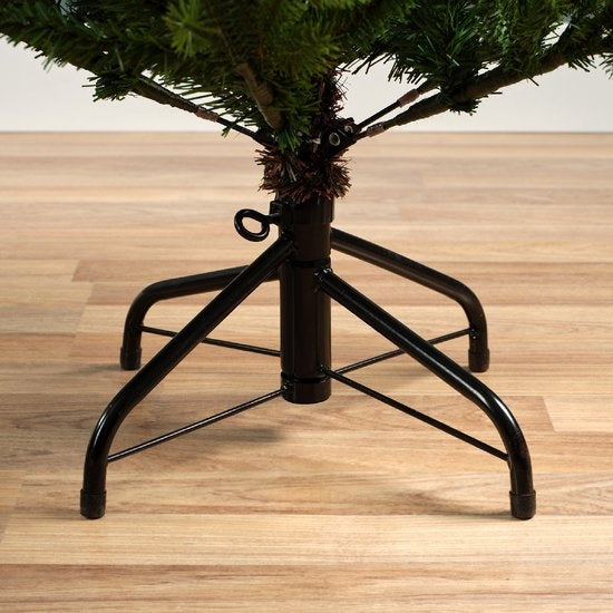 Kunstkerstboom met bruine stam en zwarte metalen standaard met drie poten