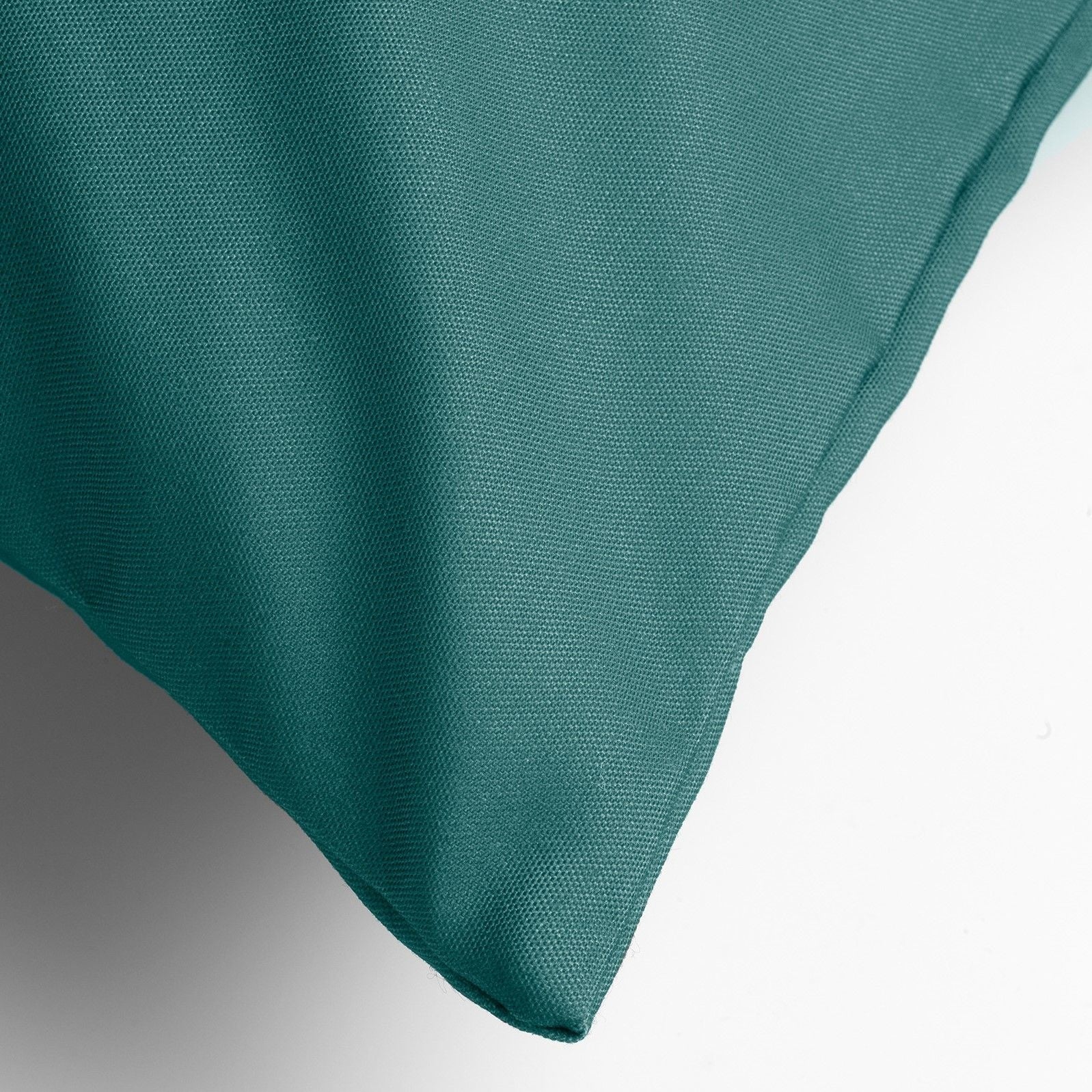 Teal groen sierkussen, hoekdetail met fijne geweven stof