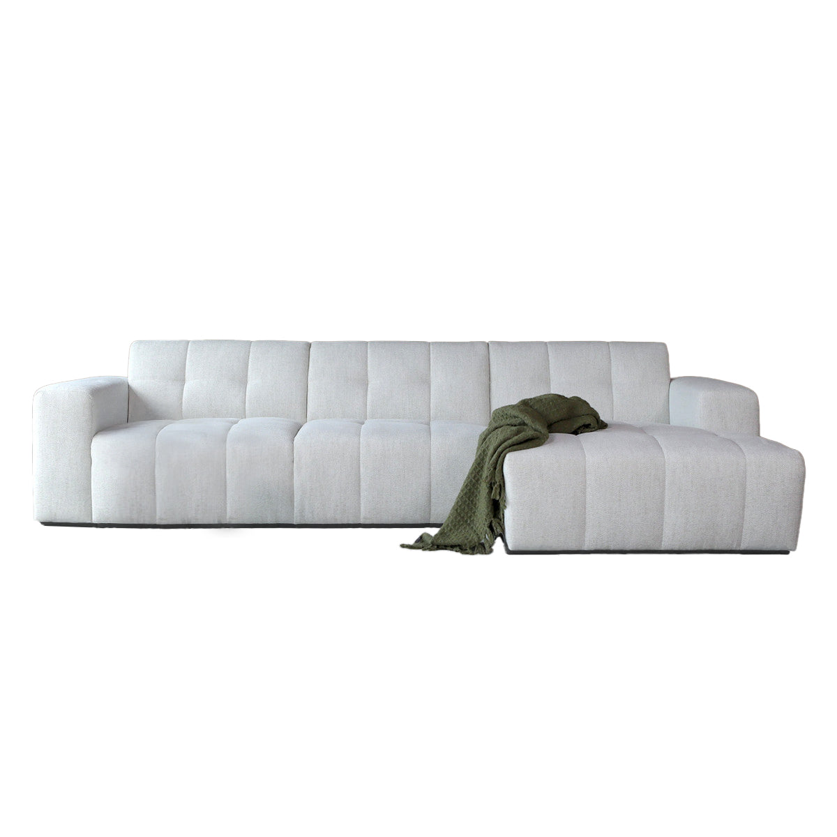 Bank met chaise longue rechts in witte stof, met groene plaid op zit