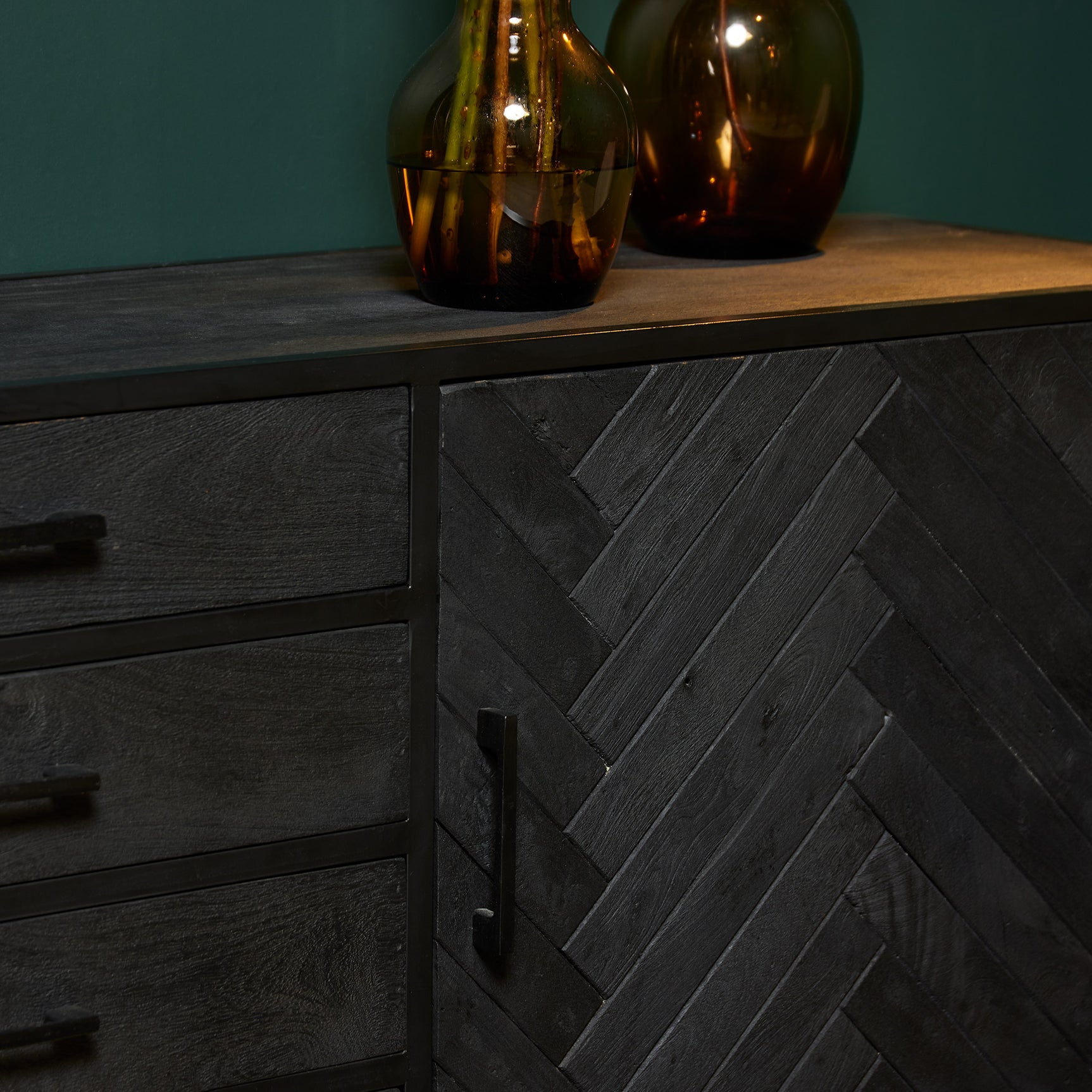 Dressoir ladefront met visgraat motief en zwarte greep, donker houten lade