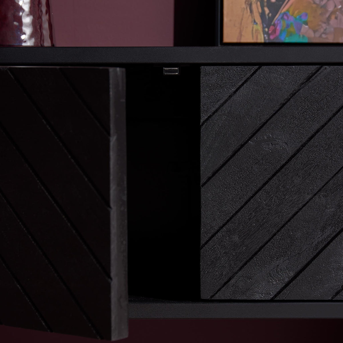 Zwevend tv-meubel met herringbone zijpanelen en open vak met zwarte binnenkant, donkergrijs.