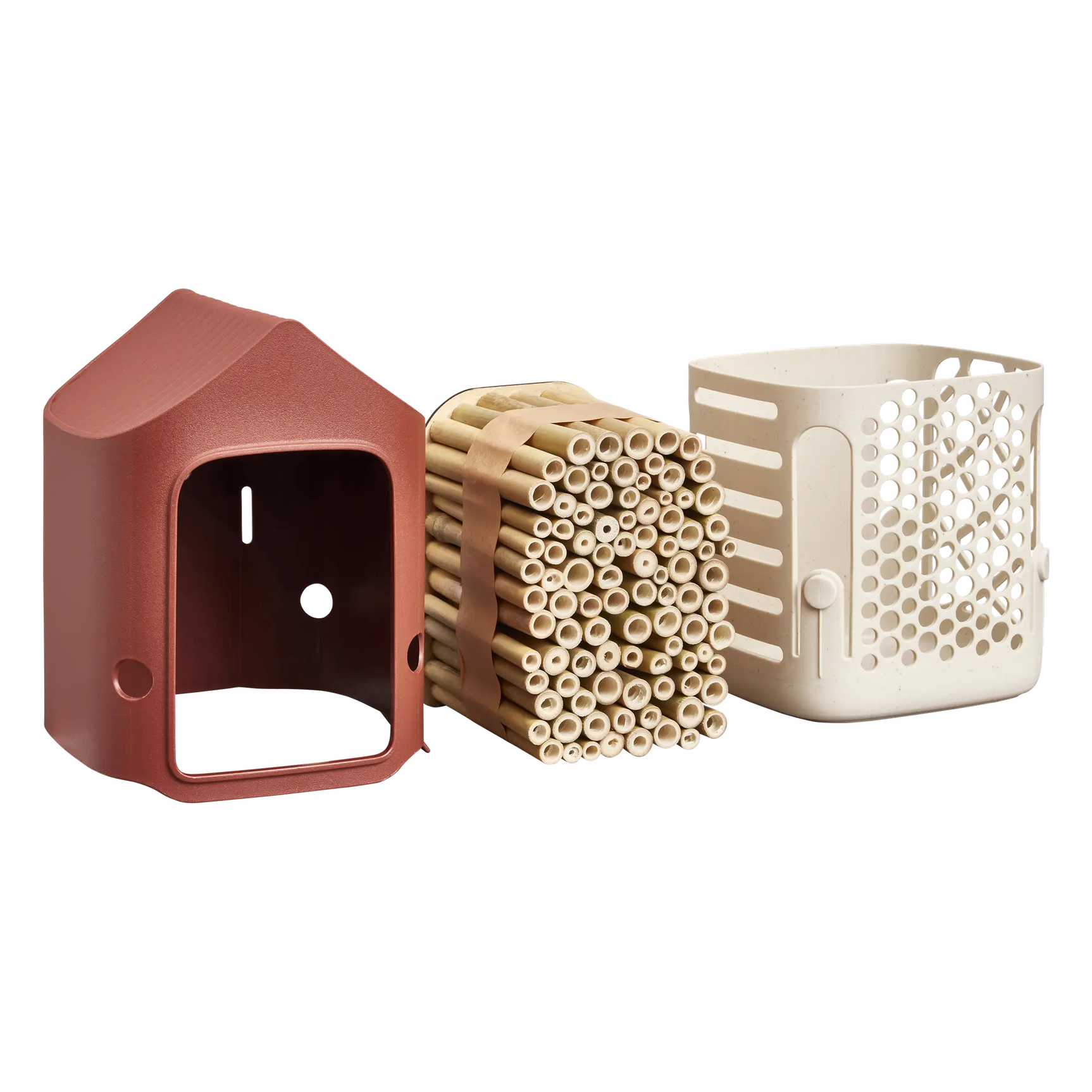 Insectenhotel met rood huisje en losse inzet met houtachtige holletjes; wit onderdeel erbij