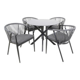 Tuinset met ronde tuintafel, zwart metalen pootkruis en grijze kussens op draadstoelen