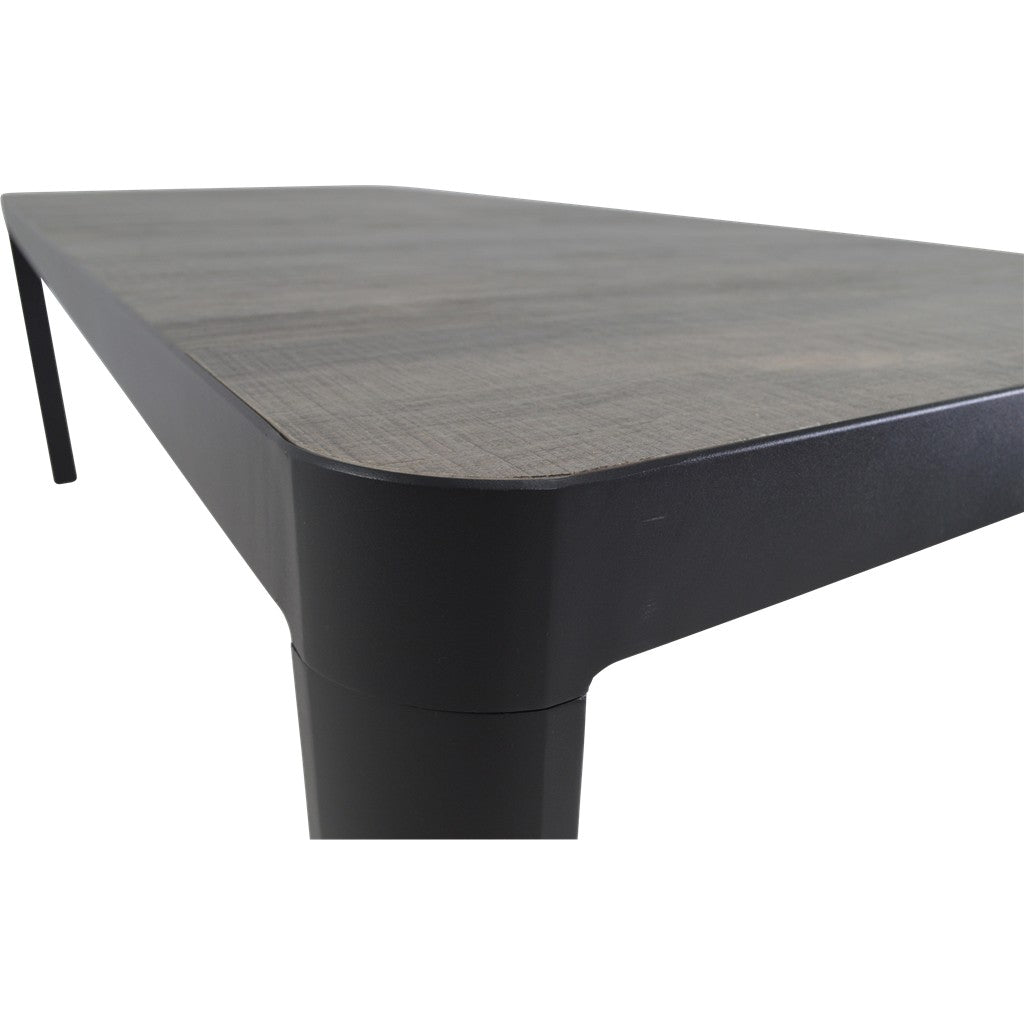 Hoekdetail eettafel met grijs houtlook blad, zwarte rand en poot