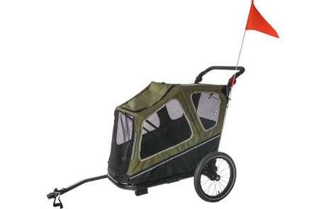 Groene fietskar met afdekzeil, doorzichtige panelen en rode vlag, zwenkbaar stuurwiel