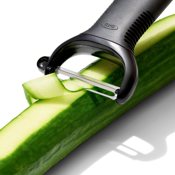 OXO dunschiller Y-model met snijblad op komkommer; schil in slierten