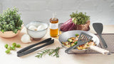 GastroMax spatel met sleuven, grijs, schept groenten uit een kom.
