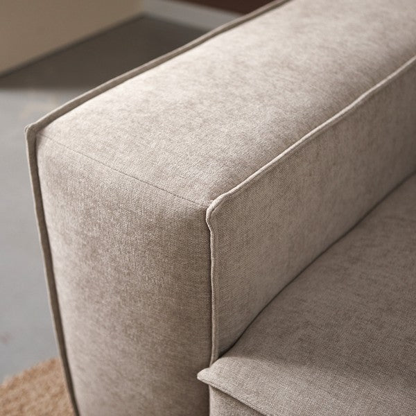 Chaise longue met lichtbeige stoffen zitting en afgeronde hoek, zichtbare naden