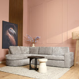 Beige stoffen divan met chaise links en drie rugkussens, afgeronde vorm