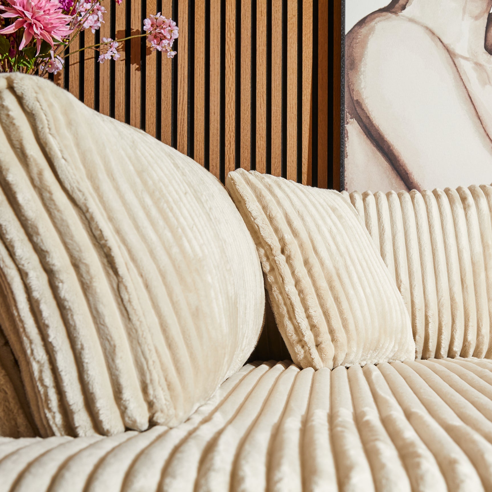 Beige Teddy bank met ribstructuur, ronde kussens en sierkussens