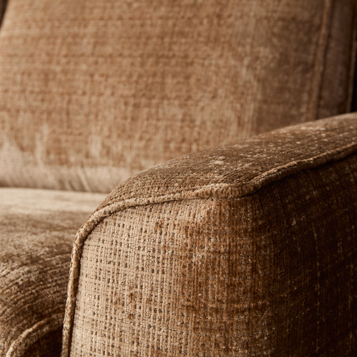 Hoekbankbekleding van beige teddygeweven stof met zichtbare textuur en stiknaden
