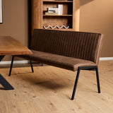 Bruine eetkamerbank met ribbelstoffering, brede zitting en rugleuning, zwarte metalen poten.