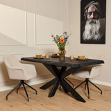 Boomstamtafel met donker blad en zwarte, gekruiste pootconstructie