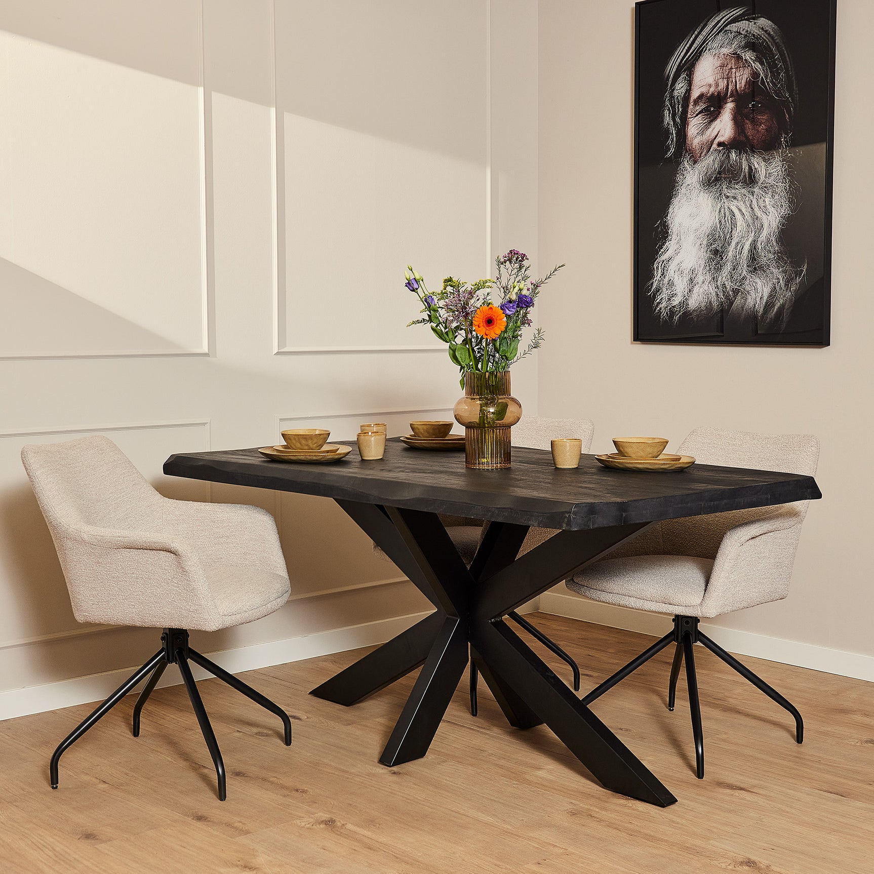 Boomstamtafel met donker blad en zwarte, gekruiste pootconstructie
