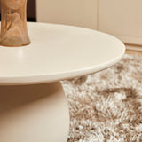 Ronde salontafel met wit blad en ronde zuilbasis, close-up